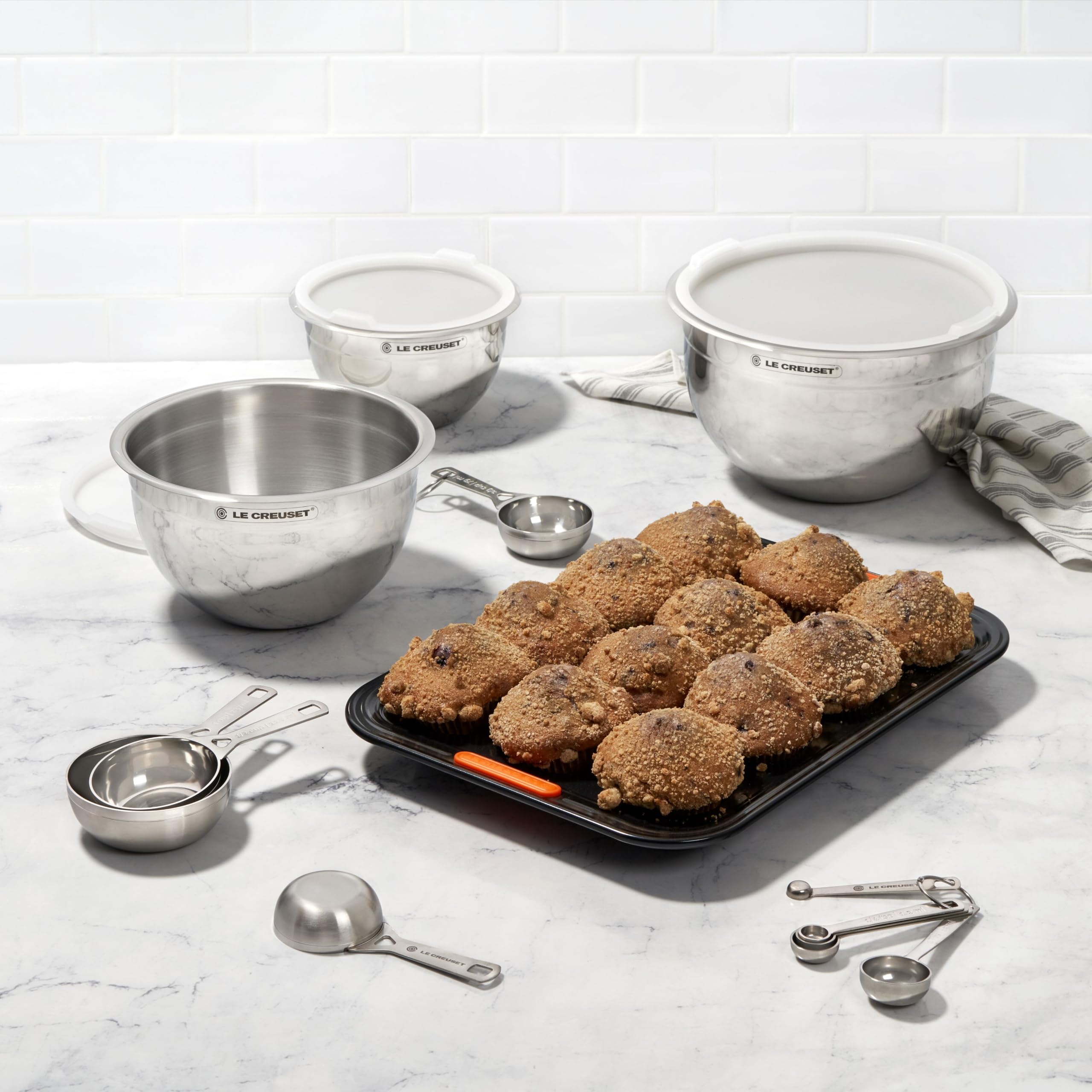 Le Creuset cups staged on counter matching stainless cookware aesthetic