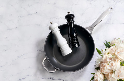 Le Creuset mills on a dining table, showing stylish tabletop presence