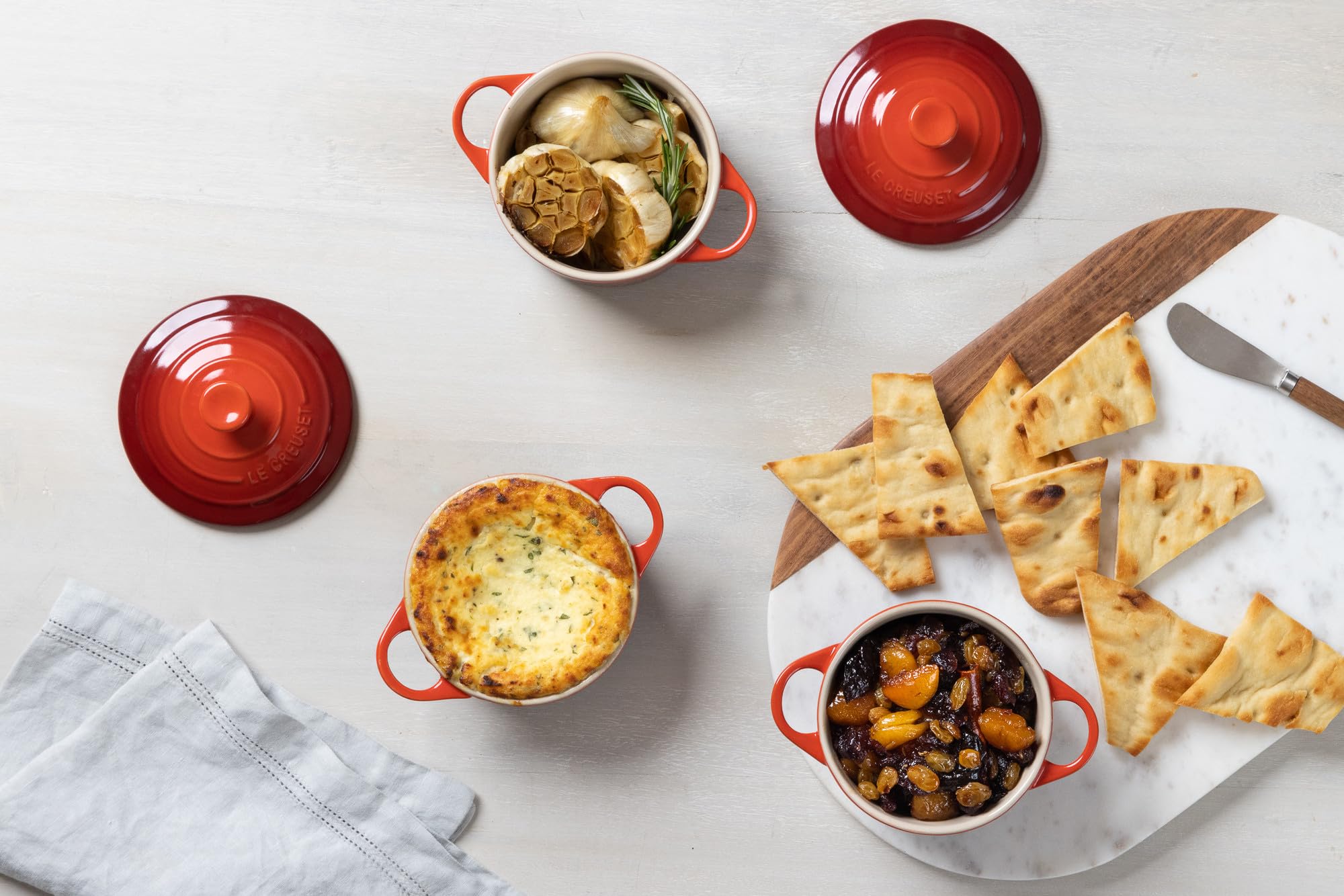 Le Creuset mini cocotte set with included cookbook showing recipe inspiration benefit