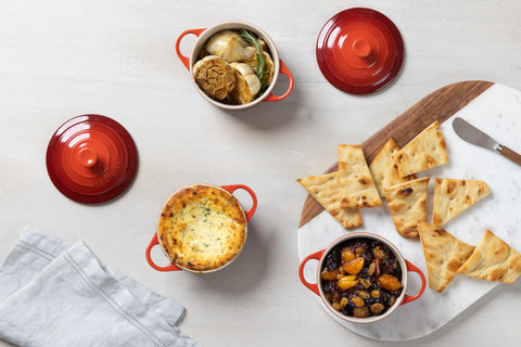 Le Creuset mini cocotte set with included cookbook showing recipe inspiration benefit