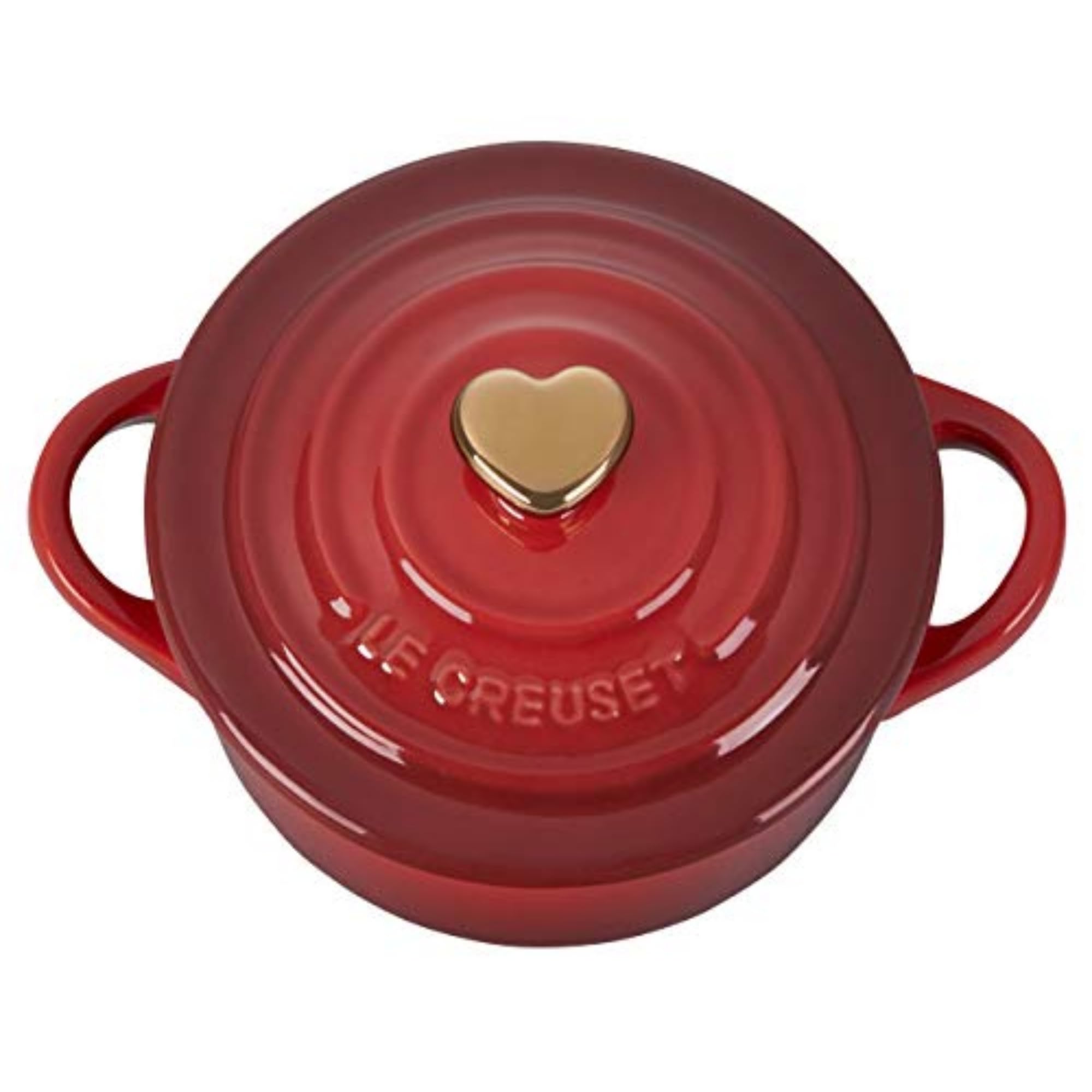 Le Creuset gold heart knob close-up highlighting decorative detail