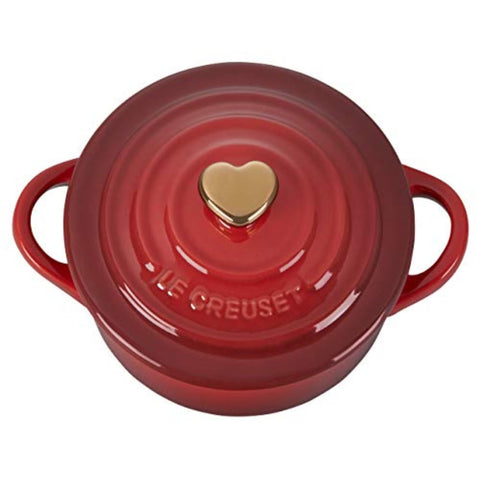 Le Creuset gold heart knob close-up highlighting decorative detail