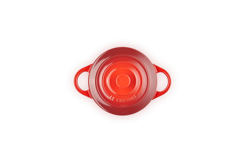 Le Creuset mini cocotte lid close-up showing glaze and secure fit for spill protection