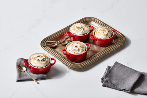 Le Creuset mini cocotte next to measuring cup showing 8 oz scale and portion size
