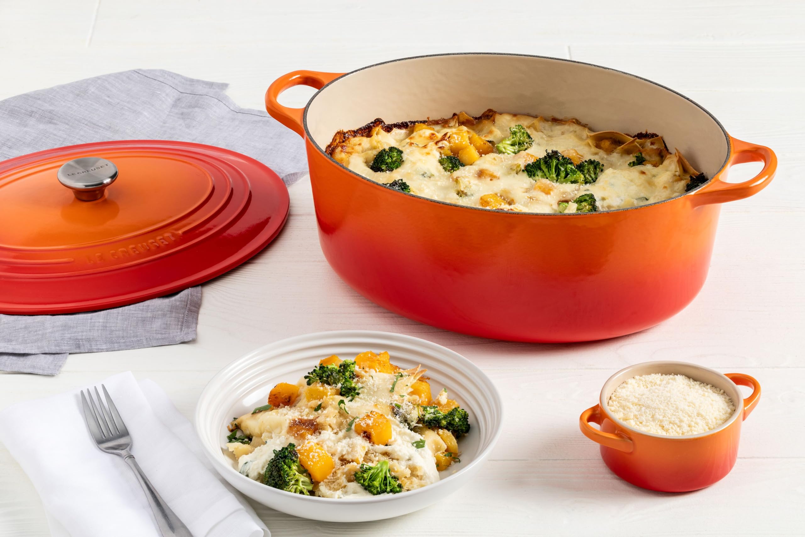Le Creuset oval Dutch oven beside measuring cup showing 8 qt. capacity