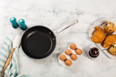 Le Creuset pepper mill being used at table, adds vibrant color and convenience