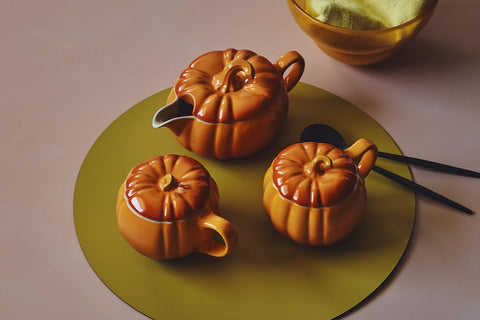 Le Creuset pumpkin gravy boat on table adding festive presentation