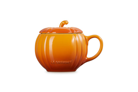 Le Creuset pumpkin mug in use with hot drink, demonstrating warmth retention and seasonal charm