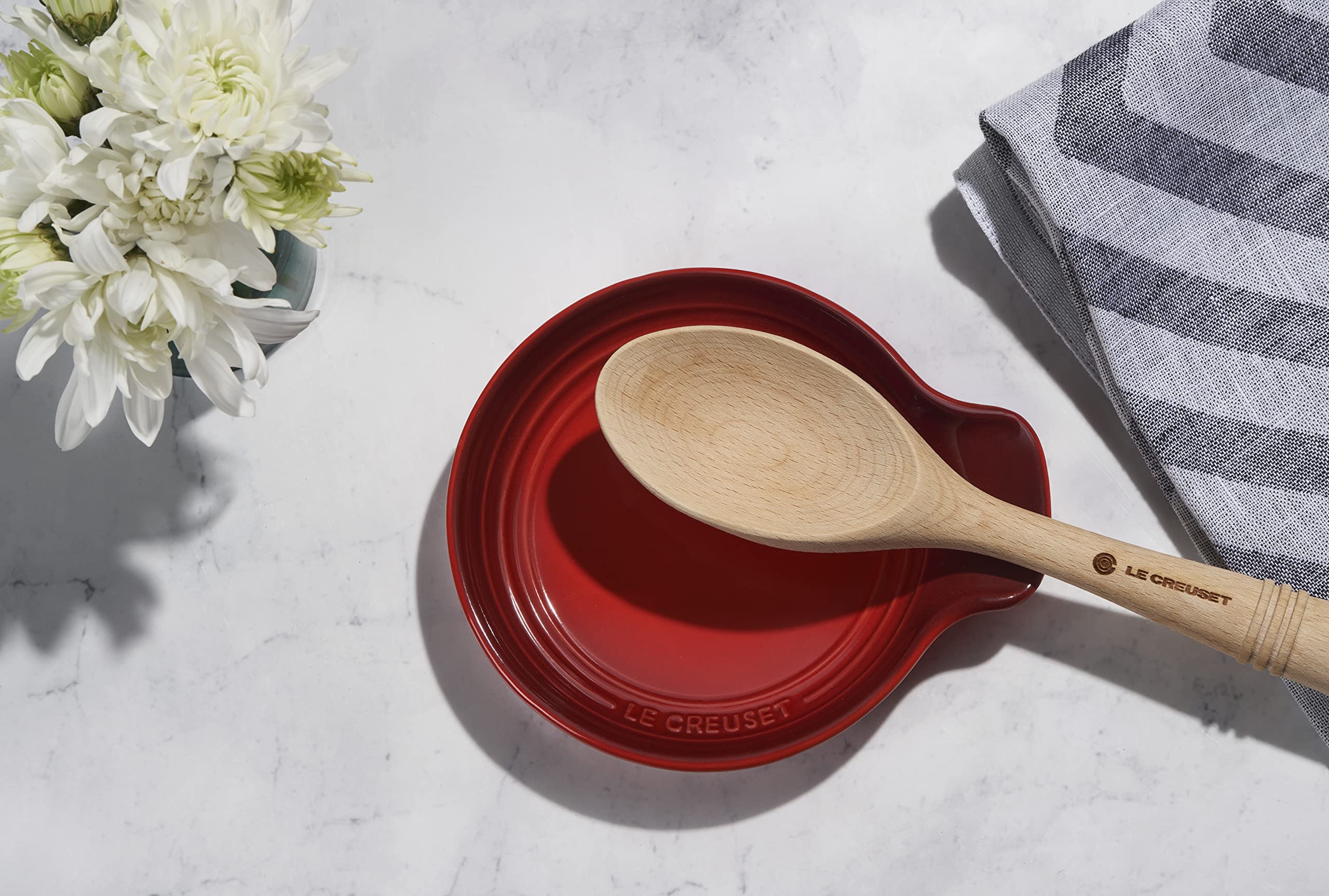 Le Creuset spoon stirring simmering pot with sturdy handle for improved control