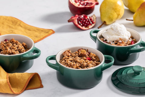 Le Creuset mini cocotte held in hand for size comparison, highlighting compact portion control