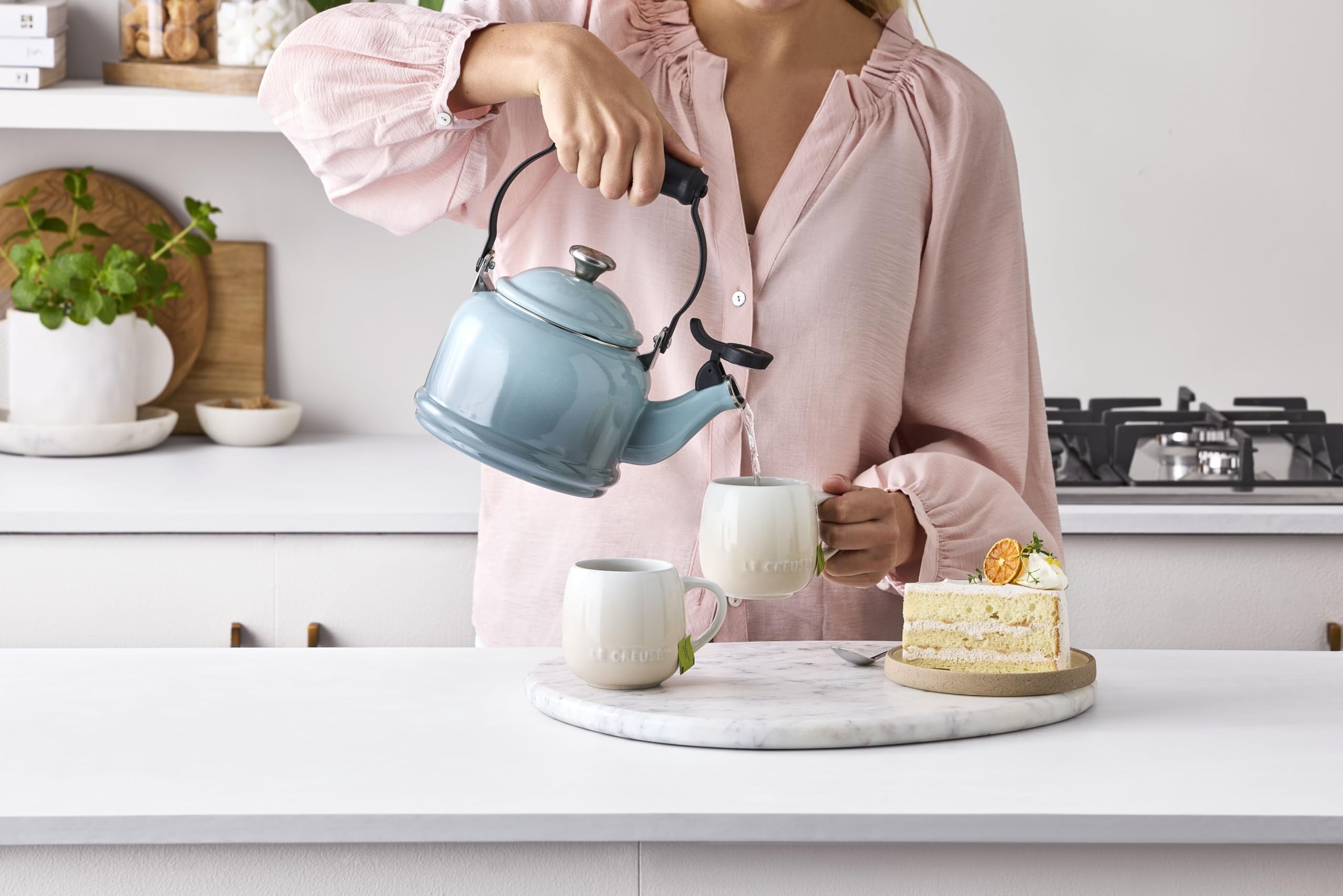 Le Creuset kettle beside a mug showing 1.25 qt scale for single-serve use