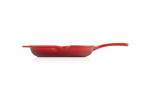 Le Creuset skillet on stovetop in use showing even heat distribution benefit