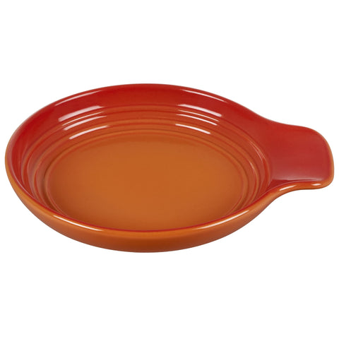 Le Creuset spoon rest front view in Flame showing compact shape and neat drip containment