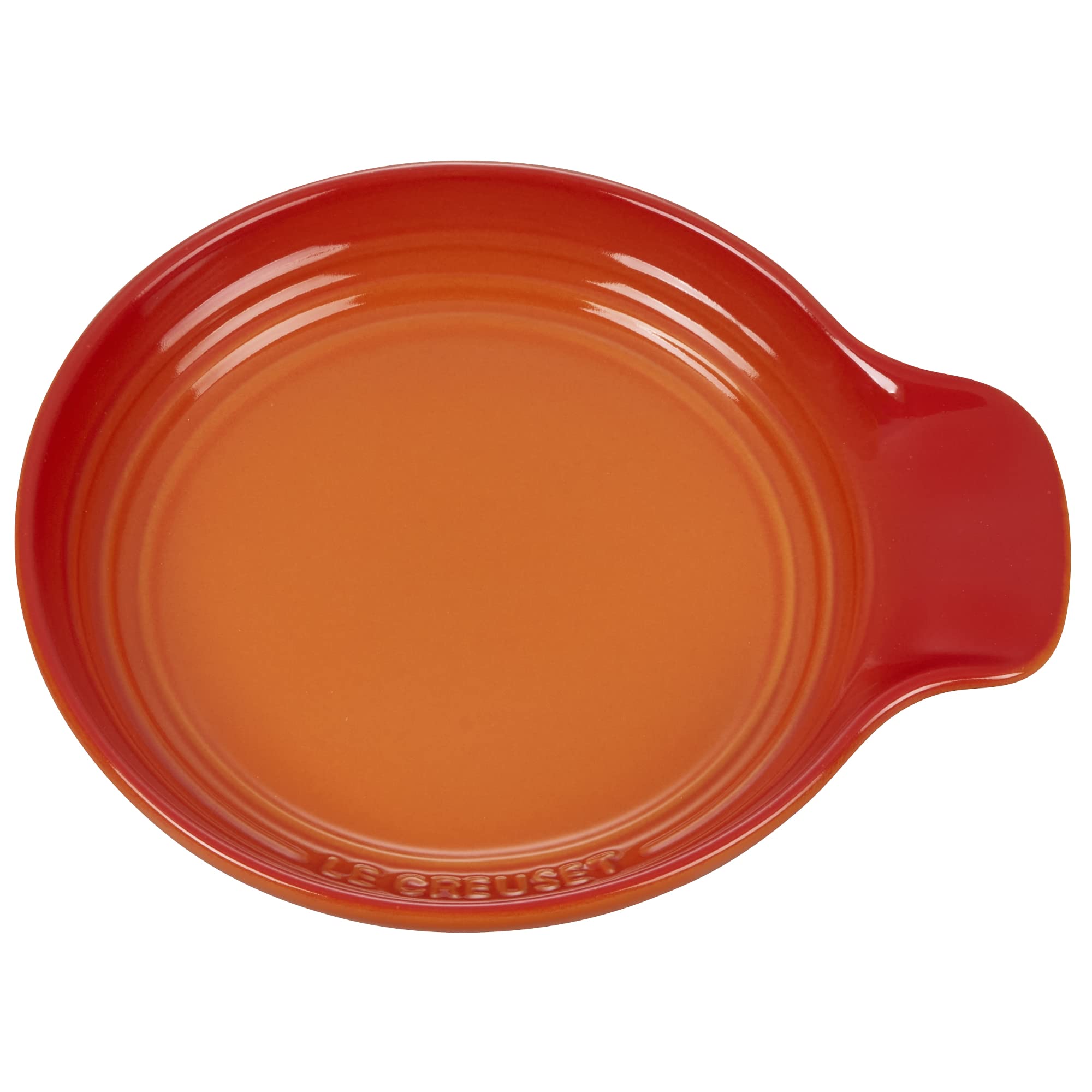 Le Creuset spoon rest beside a saucepan in kitchen demonstrating tidy countertop protection