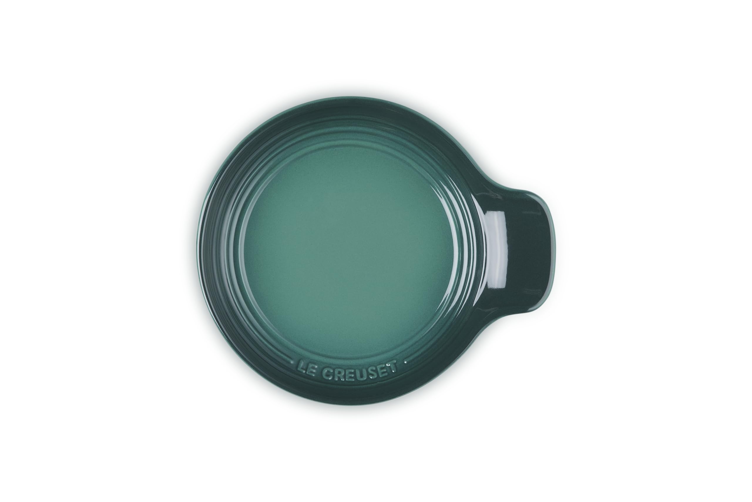 Le Creuset spoon rest in kitchen use holding a wooden spoon to keep counters clean