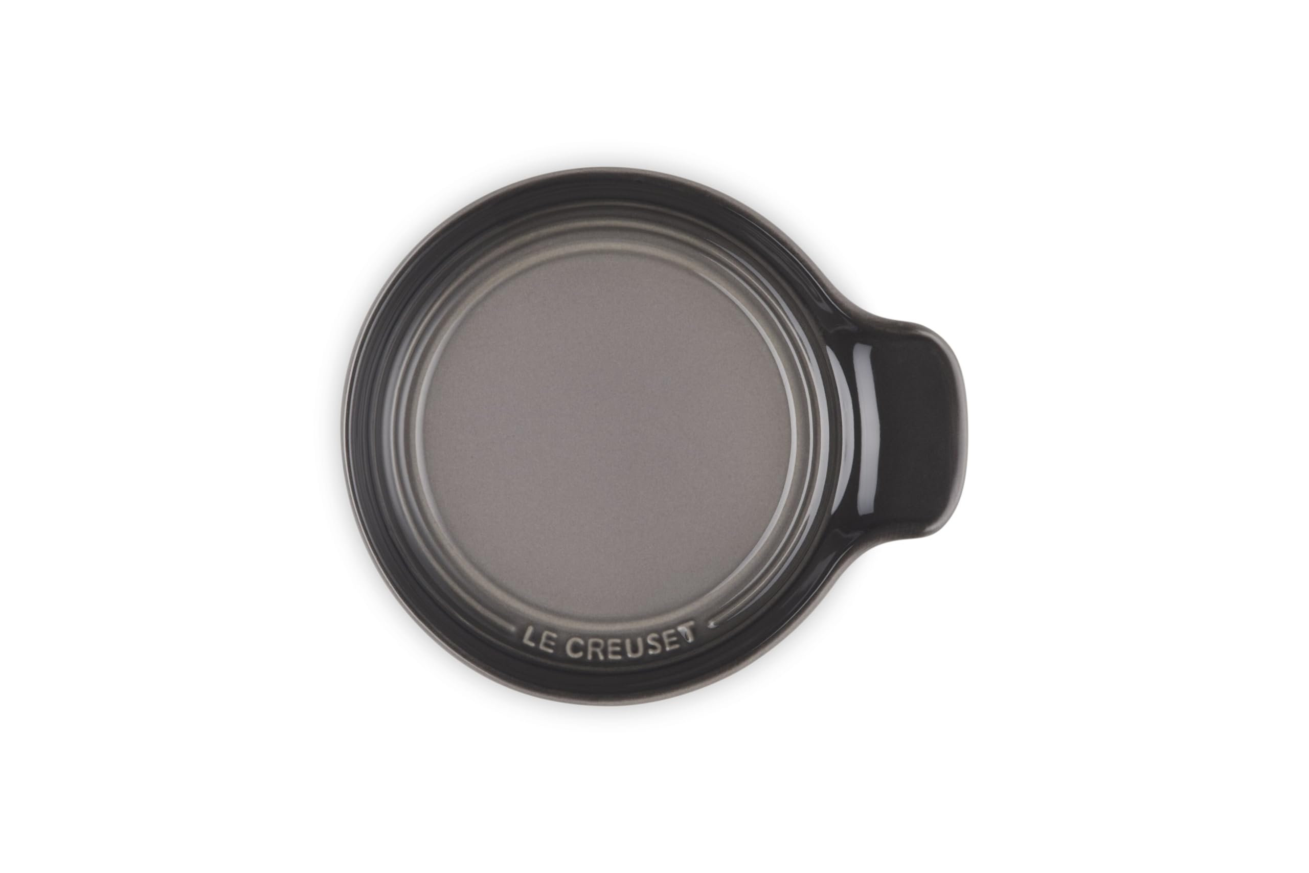 Le Creuset spoon rest next to a standard spoon showing compact 6-inch size benefit
