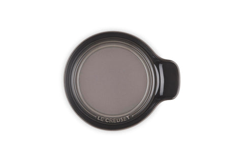 Le Creuset spoon rest next to a standard spoon showing compact 6-inch size benefit