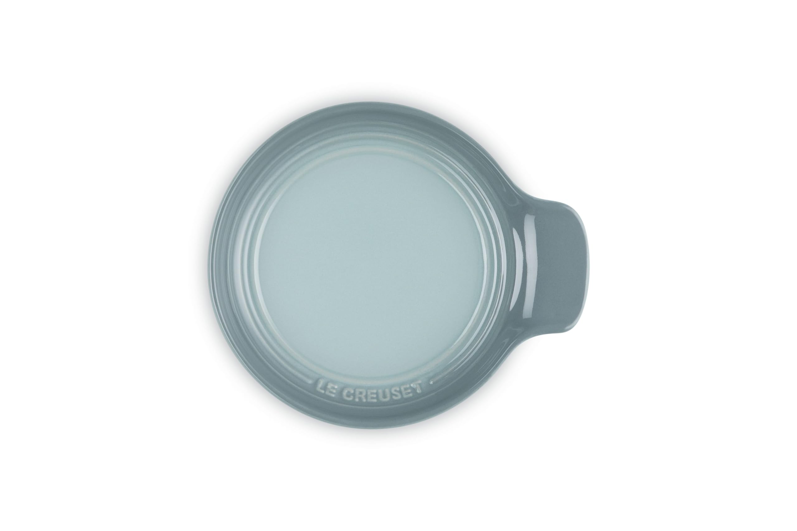 Le Creuset spoon rest supporting spatula and tongs for organized cooking benefit
