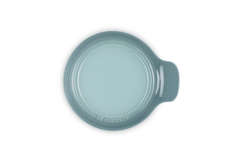 Le Creuset spoon rest supporting spatula and tongs for organized cooking benefit