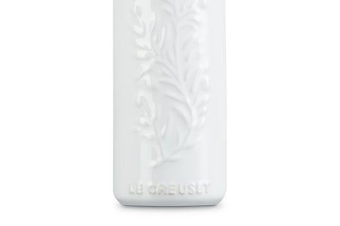 Le Creuset stainless steel nozzle pouring olive oil for precise drip‑free control