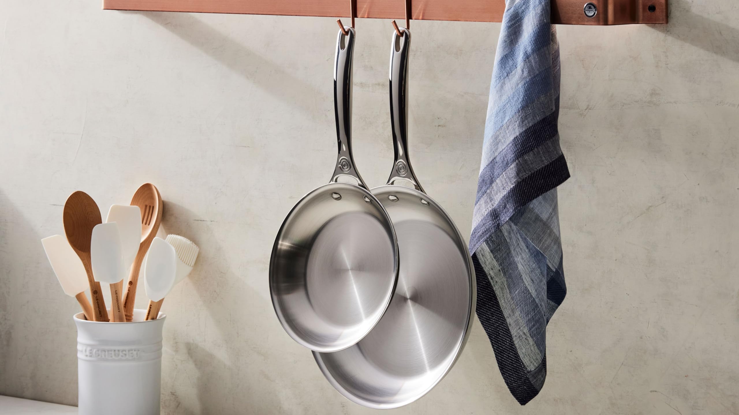 Le Creuset stoneware crock beside common kitchen items showing scale