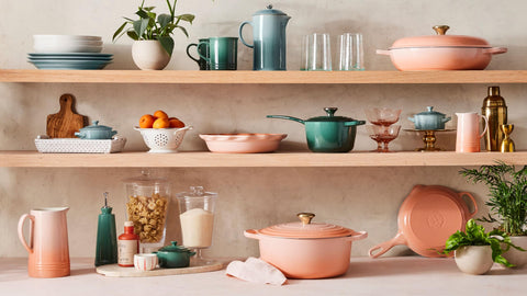 Le Creuset mug beside a smartphone for scale showing 14 oz capacity and serving size benefit