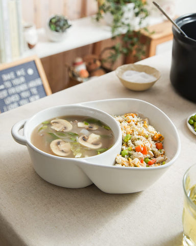 LE TAUCI bowl next to spoon to show scale and portion-friendly size benefit