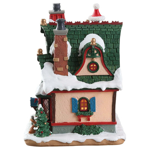 Lemax Claus Cottage interior scene closeup illuminating figurines and enhancing storytelling