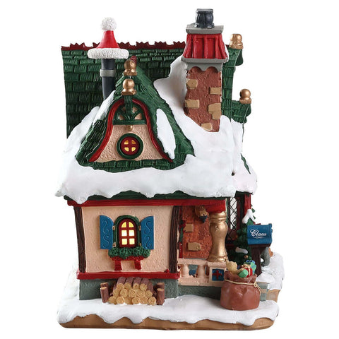 Lemax Claus Cottage held by hand to show scale and placement flexibility for displays