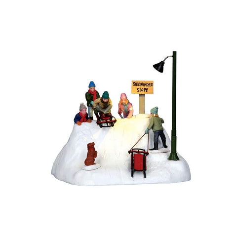 Lemax piece placed in a village scene demonstrating portable, battery-powered placement