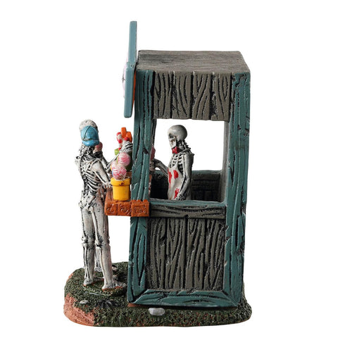 Lemax rotten candy stand in village setting creating eerie Halloween ambiance