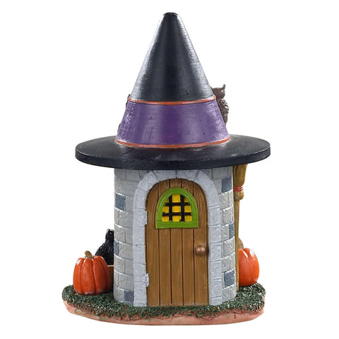 Lemax Witch's Brew styled on a mantel with other Spooky Town pieces creating atmosphere