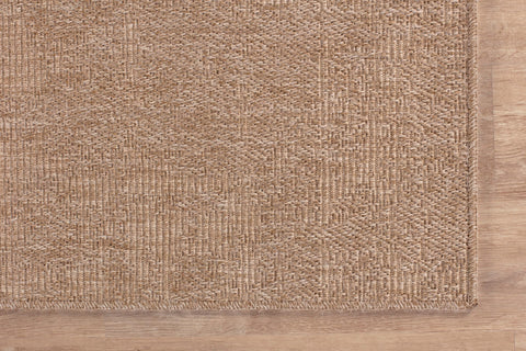 Lena Rug styled in living room under coffee table for cozy, low-maintenance warmth