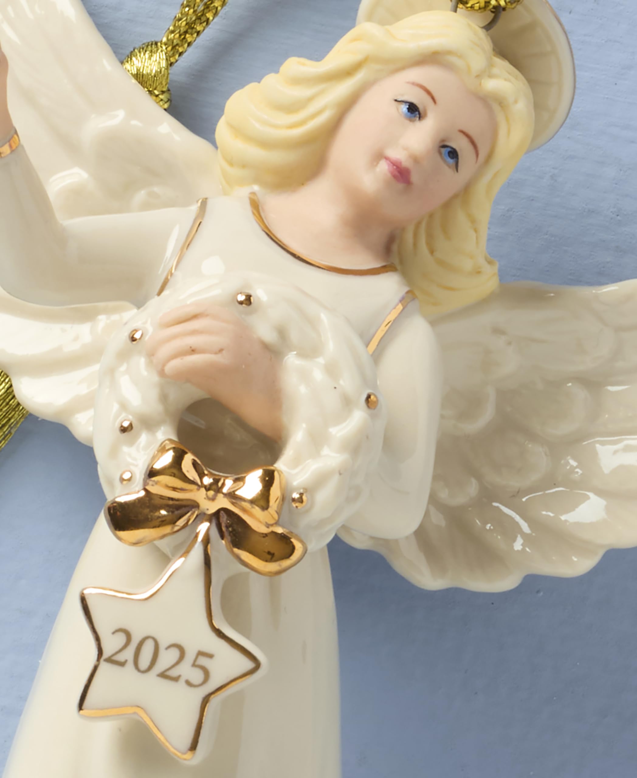 Lenox ornament hanging on a Christmas tree adding warm shimmer benefit: festive focal point