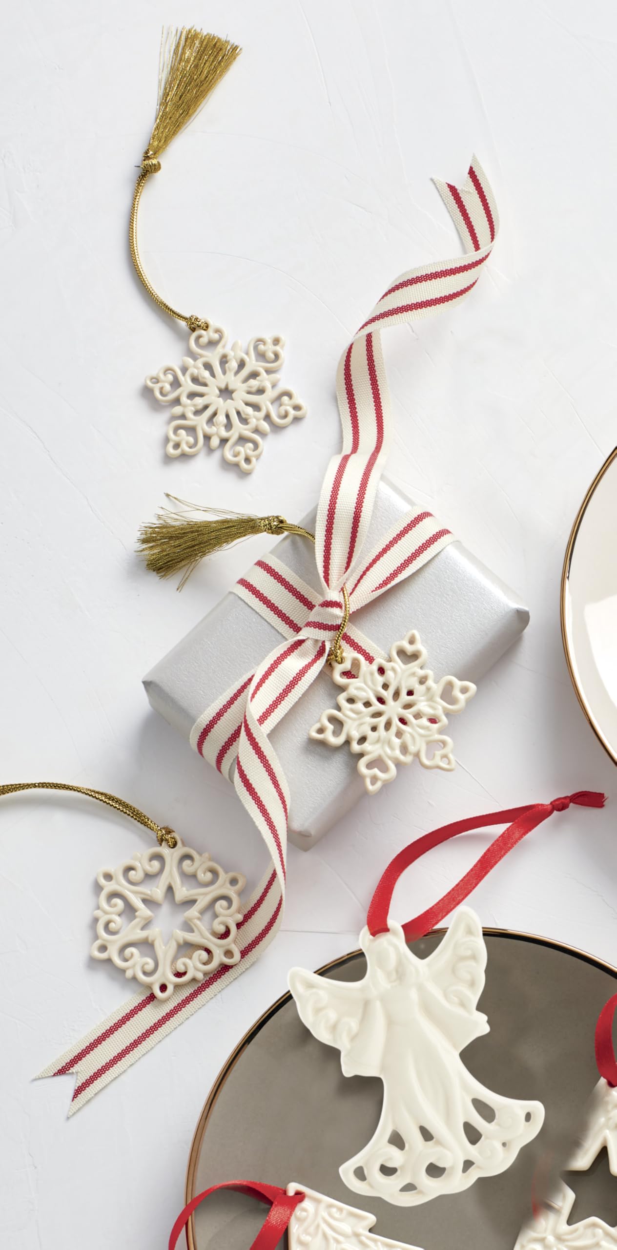 Lenox ornaments hanging on a lit Christmas tree, adding delicate texture and warmth