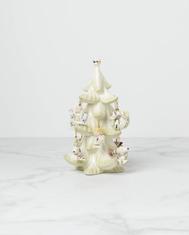 Lenox Peanuts set arranged on a mantel with ornament tree, creating a nostalgic holiday scene