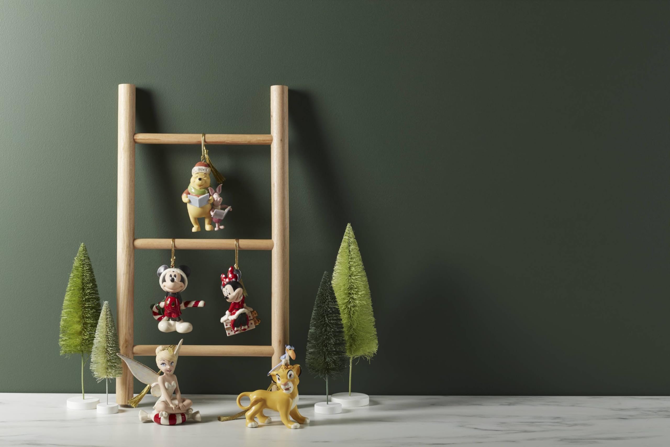 Lenox ornament hanging on a Christmas tree adding nostalgic Disney cheer