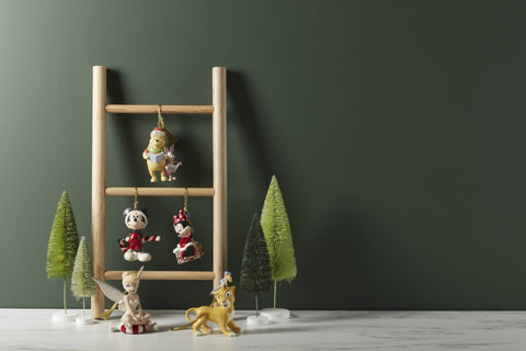 Lenox ornament hanging on a Christmas tree adding nostalgic Disney cheer
