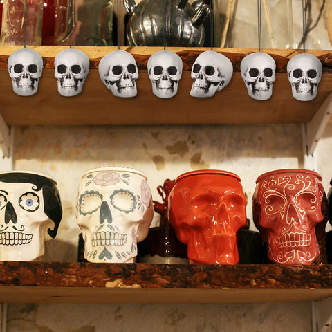Lenwen skulls wrapped in cobwebs creating layered spooky holiday styling