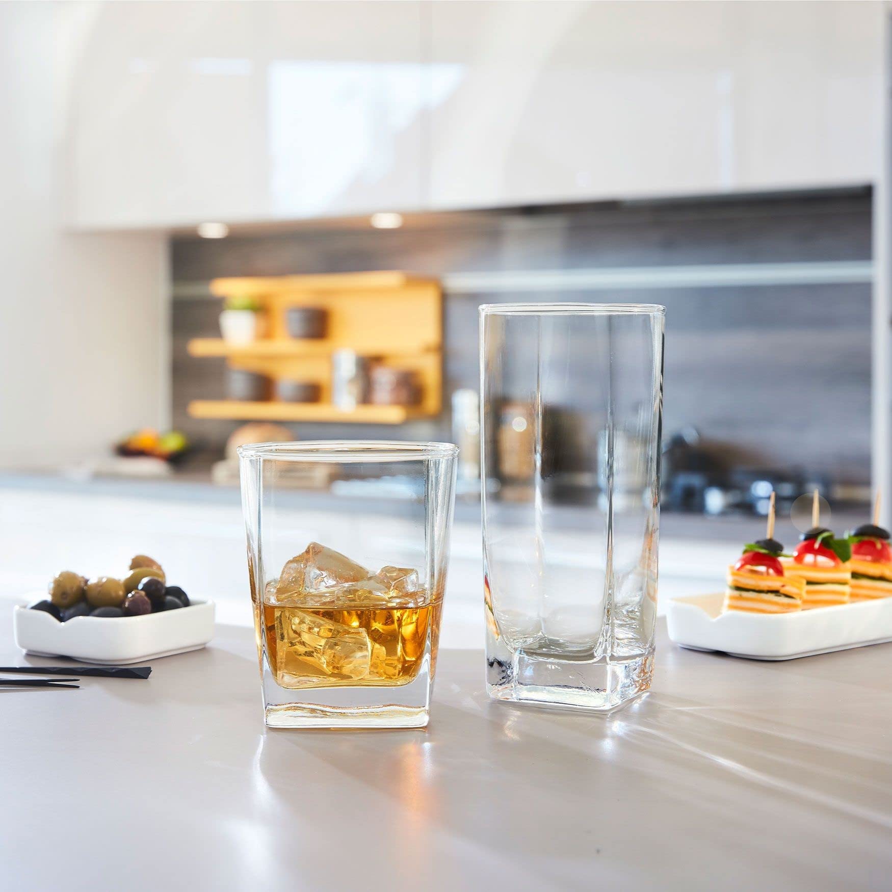 Le'raze paired tall and short glasses on table demonstrating matching set benefit