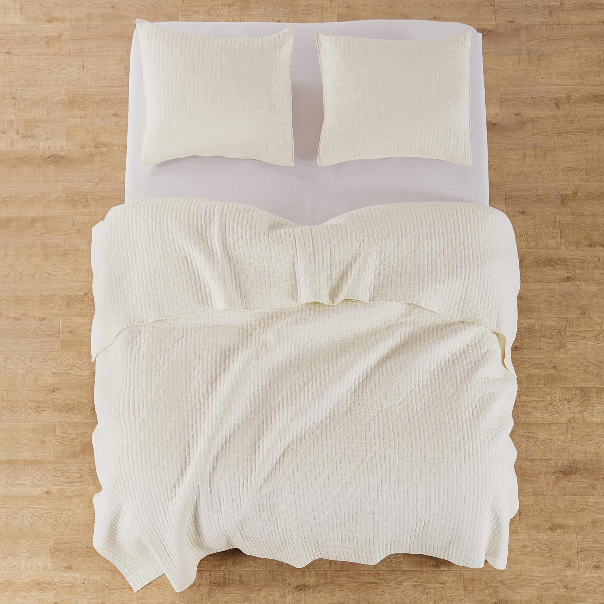 Levtex Home quilt on bed with ruler for size comparison and accurate scale