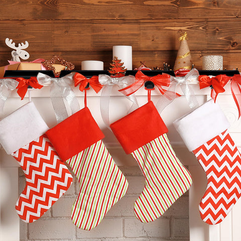 Liengoron holders in use on a mantel holding stockings for tidy holiday display