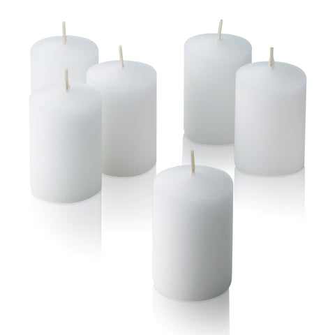 Light In The Dark lit votives in glass holders creating warm event ambiance