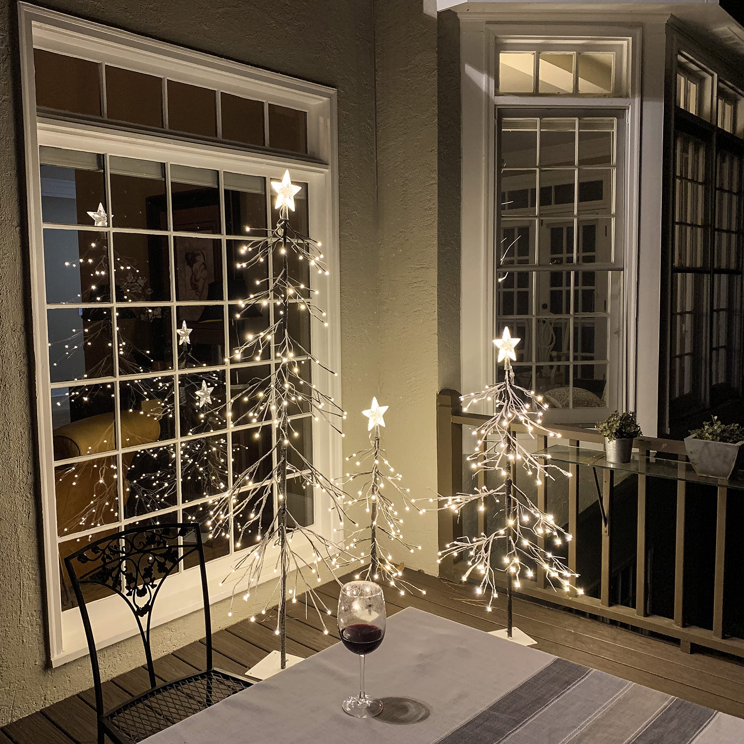 LIGHTSHARE decorated trees in living room showcasing effortless festive styling