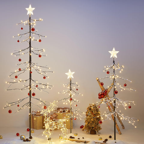 LIGHTSHARE trees illuminated at night creating warm-white glow for atmosphere