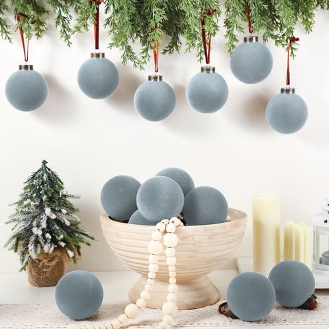 Liliful dusty blue balls hung on tree creating elegant muted contrast