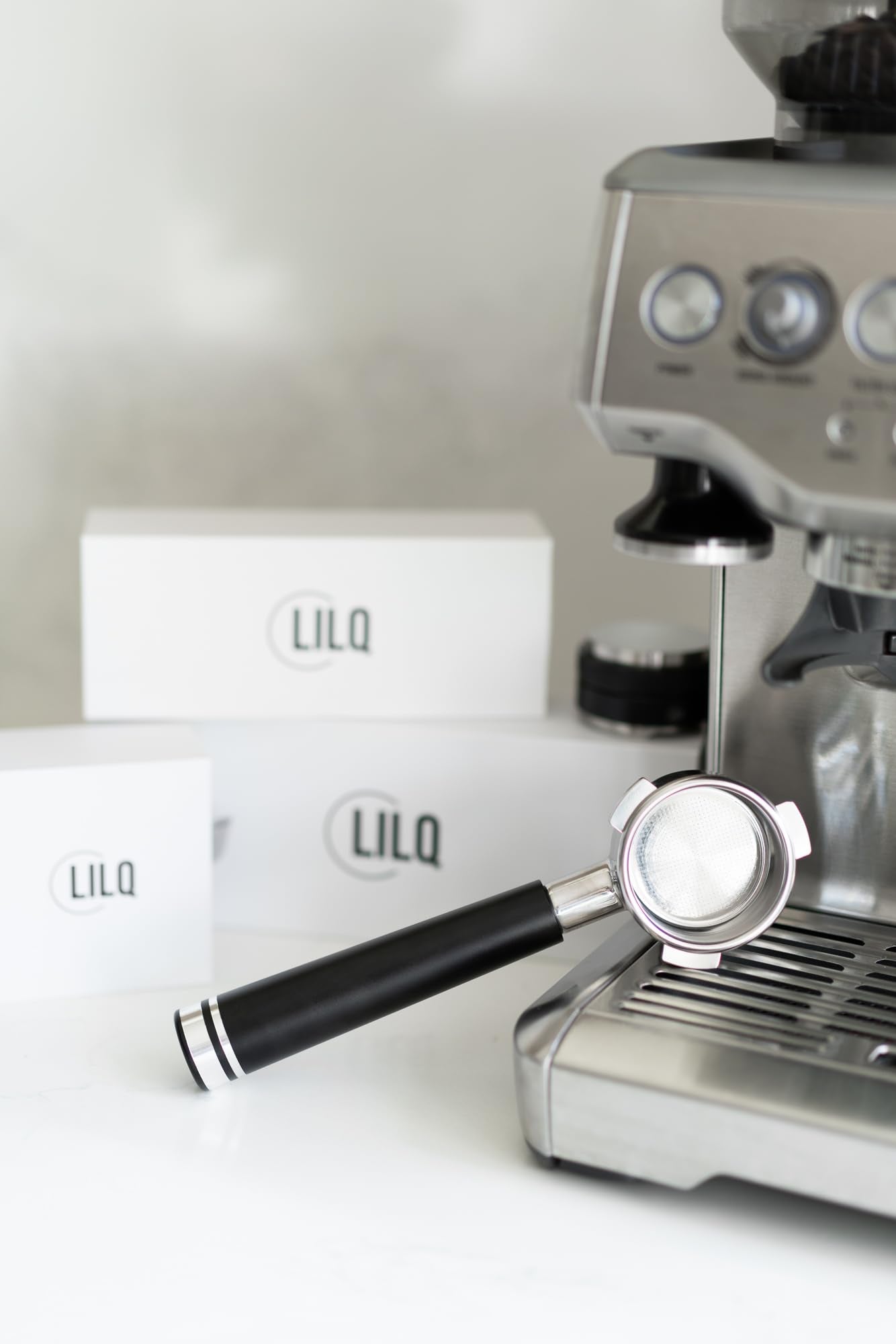LILQ portafilter next to stock Breville handle showing size and build upgrade