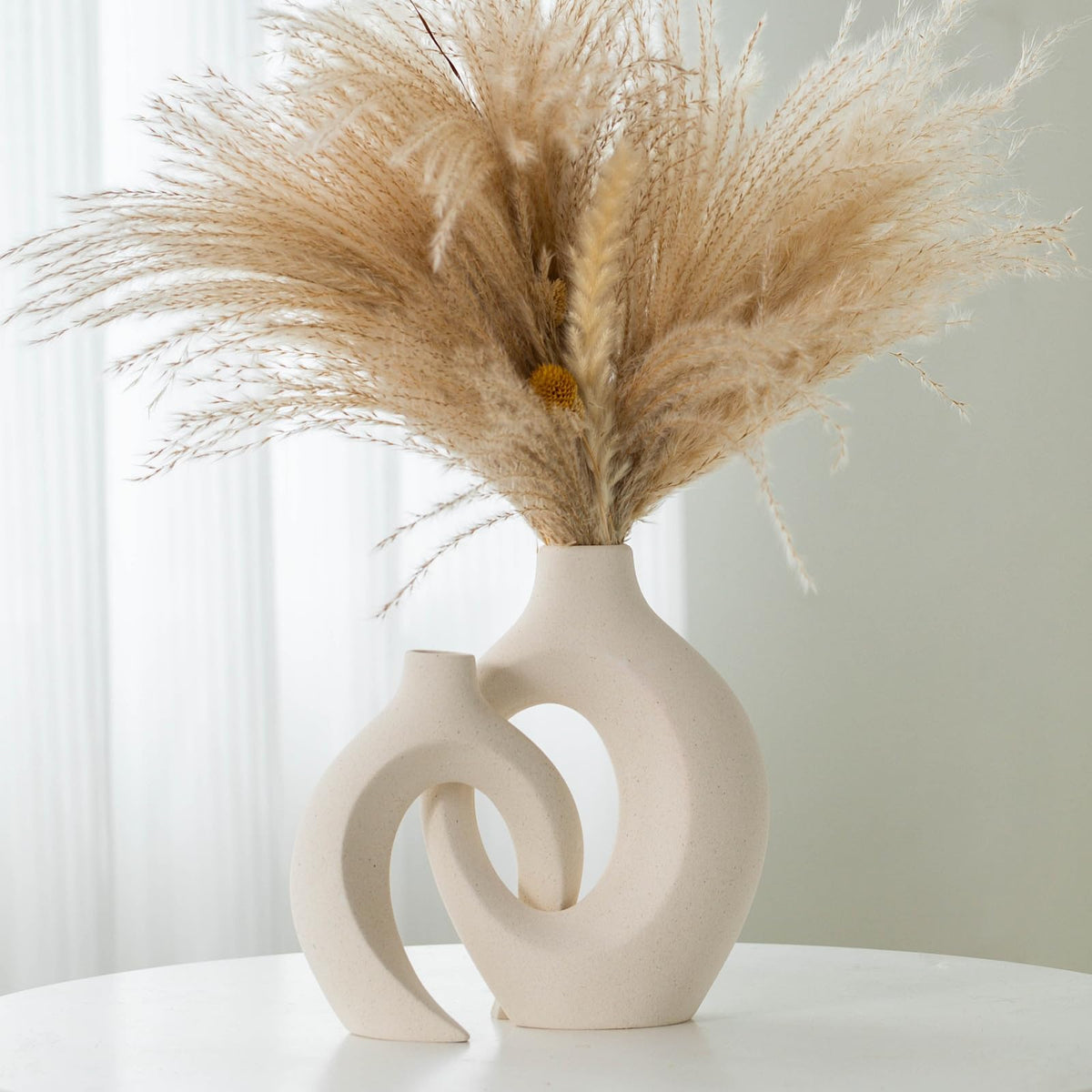 Liotww front view of paired vases showing sculptural embrace and decorative impact