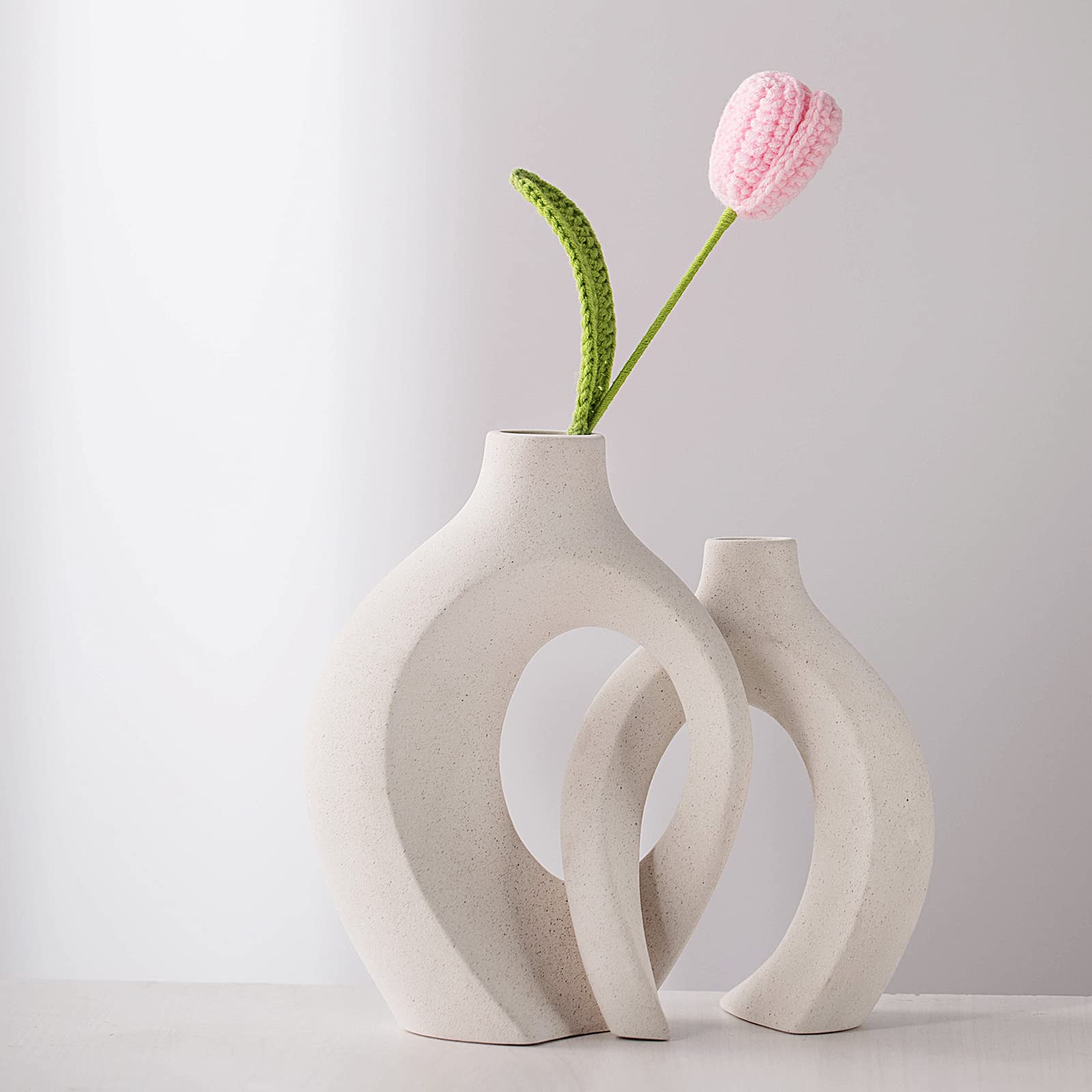 Liotww vase next to a hand for scale illustrating actual dimensions