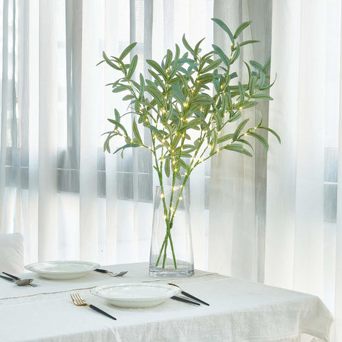 LITBLOOM branch on covered porch at dusk, provides weather-resistant outdoor ambiance